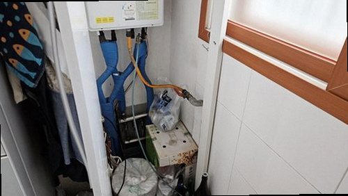 김포 누수탐지 싱크대 하부장과 벽면의 누수 흔적을 확인하는 모습